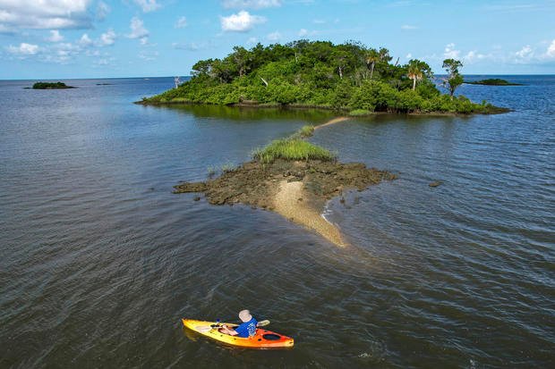 Associated Press reporter Richard Lardner kayaks to Sweetheart Island, off the coast of Yankeetown, 